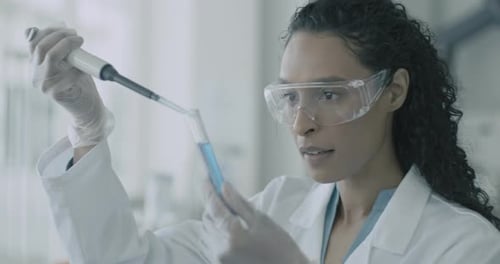 Close-up of Female scientist Holding Chemical Test Tubes in Laboratory