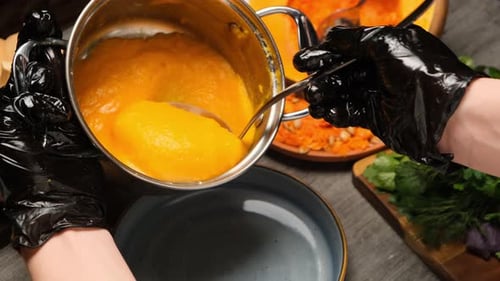 Cook Using Stainless Ladle to Serve Hot Pumpkin Puree Soup Into Bowl Eating Pumpkin Porridge Hot