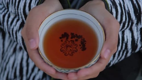 Warm Cup of Tea in a Traditional Uzbek Bowl Emitting a Soothing Aroma