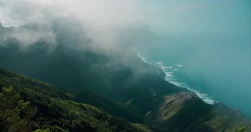 Thick Foggy Clouds Descending the Mountain Landscape on Ocean Coastline