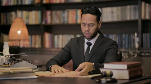 Middle Aged Lawyer Reading Book in Court