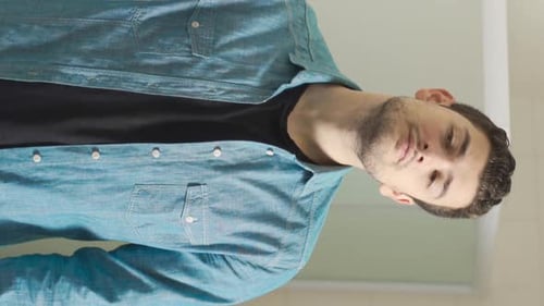 Young Adult Man Applies Cologne in Bathroom