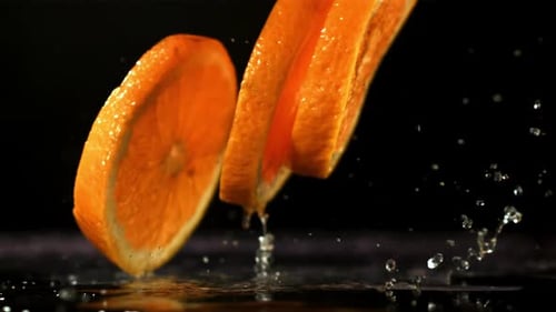 Orange Slices Fall on the Table Filmed is Slow Motion 1000 Fps