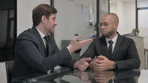 Angry Businessman in Argument with Mixed Race Teammate