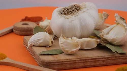 Garlic, Spices, and Herbs on a Cutting Board