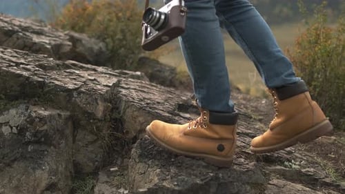 Hiker Tourist Traveler Man with Boots Camera at Mountain Field Hiking Travel Landscape Stone Nature
