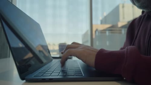 CloseUp Of Hands Typing Program Code On Laptop In Coworking Space