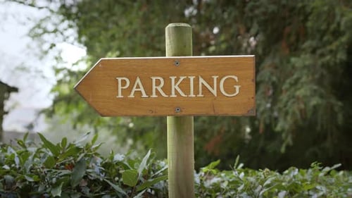 Rustic Wooden Sign - PARKING Engraved Vertically In White Capital Letters. Close-up Shot