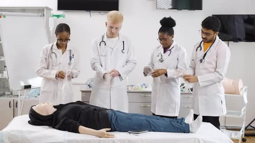 Medical Students Putting on Gloves in Hospital Room