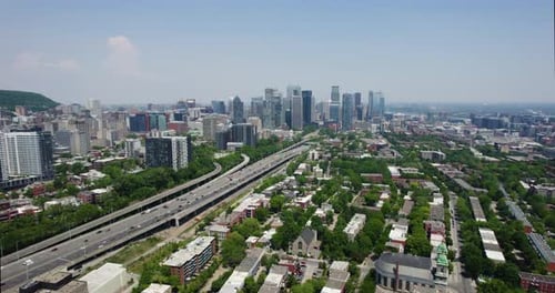 Aerial tracking shot of the Boulevard Ville-Marie and Petite-Bourgogne, in sunny Montreal, Canada