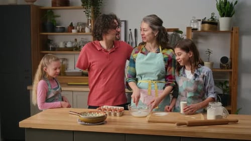 Happy Diverse Family Making Batter for Cupcakes Together