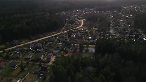 A Birdseye View of a Small Town Surrounded By a Forest Landscape