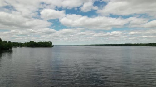 Slow-motion drone view of beautiful reflection of sky in the lake.