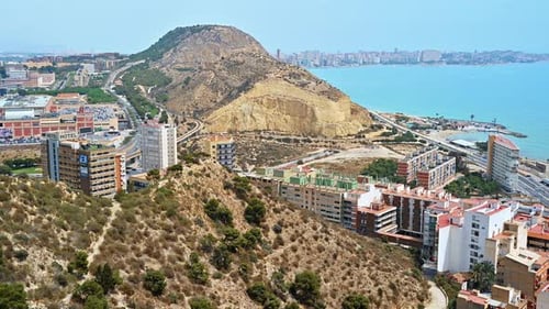 View of city and a mountain near sea shoreline in Alicante, Spain