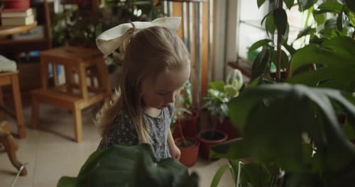 Young Girl Waters Plants in Cozy Home