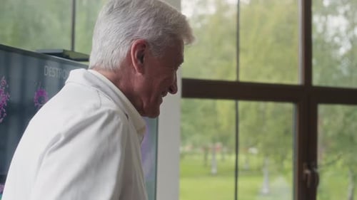 Medical Professionals Discussing Charts During a Meeting