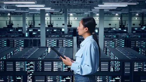 Side View Of Asian Business Woman Using Tablet An Looking Around In Data Center
