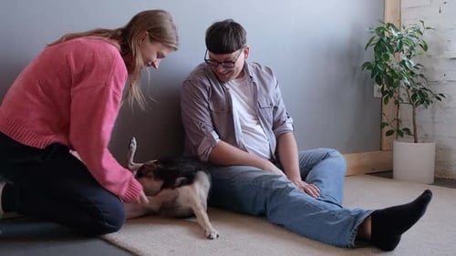 Couple at Home Petted Loving Dog
