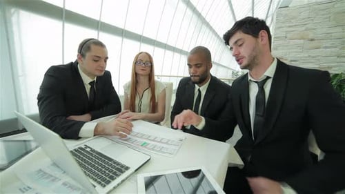 Business Team Meeting and Reviewing Documents