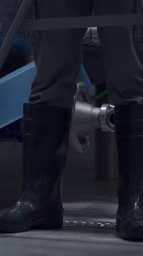 Legs Of A Worker With Protective Rubber Boots In A Brewery Medium Shot