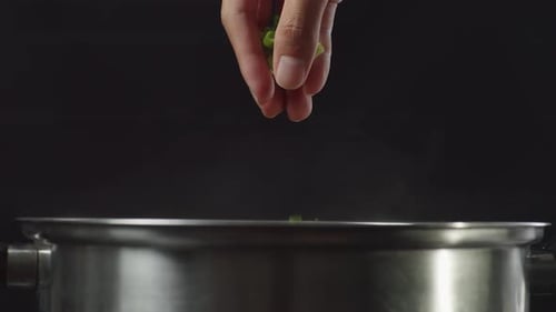 Chef's Hand Adding Chopped Green Onion In The Soup Pot. Sukiyaki, Shabu In A Pot