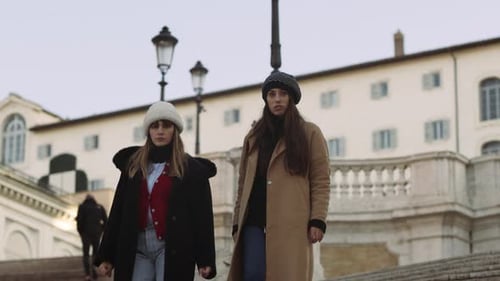 Stylish Women walking on historic steps in urban setting