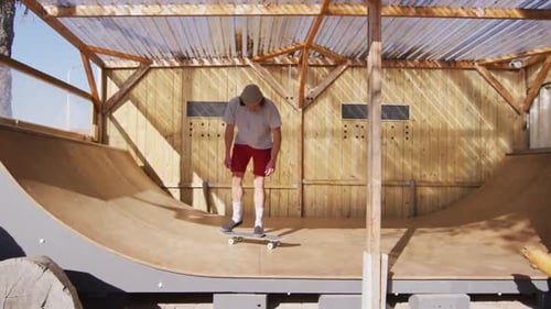 Video of caucasian male skateboarder training in skate park