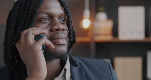 Young Adult Using a Mobile Phone in an Office