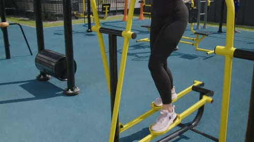 Athlete Woman Training on Cross Trainer at Outdoor Gym