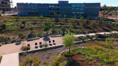 Drone Progression: Unveiling the Grey Building Amidst Gardens