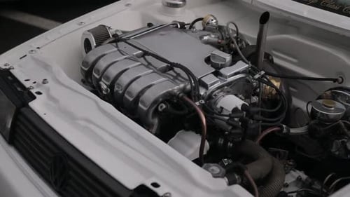 Dolly tilt of the inside of a shaved engine day on a European car.