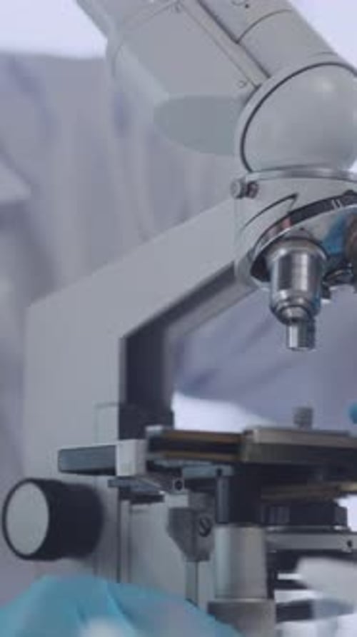 Man Uses Microscope in the Lab