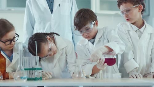 Children Conduct Science Experiment in School Lab