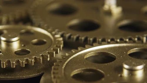 Rotating Gold Gears Interlocked in Technological Machine