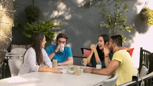 Group of friends chatting and drinking coffee
