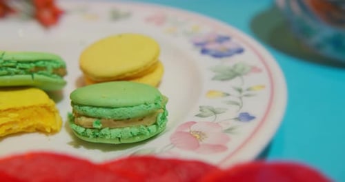 Colorful Macarons and Donut on Plate Close Up