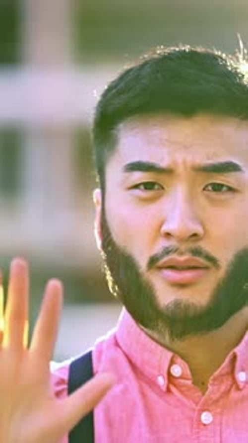 Asian Man in Casual Clothes Gesturing Stop with the Hand Outdoors