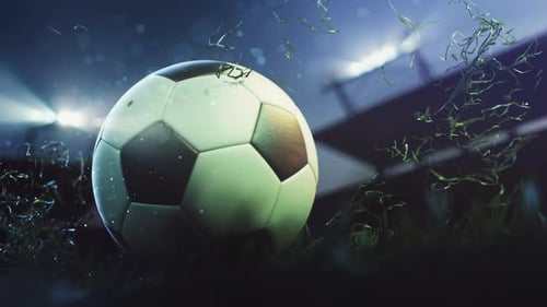 Glowing soccer ball on field at night