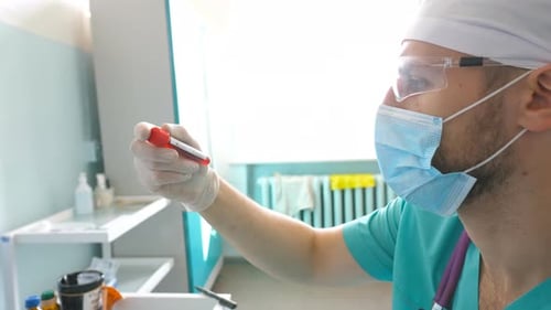 Scientist Examining Test Tube with Blood Sample to Coronavirus Lab Worker with Protective Gloves