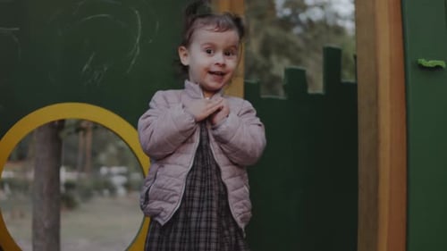 Toddler Girl Stands on the Playground Looking Around Family Child and Healthy Lifestyle Concept
