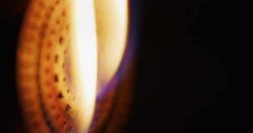 Slow motion macro of glass blowing process by professional worker with hot flame in a workshop. Sh