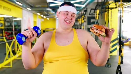 Man Working Out Holding Food at the Gym