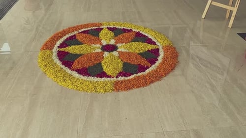 Colorful Flower Rangoli Decoration on Tiled Floor