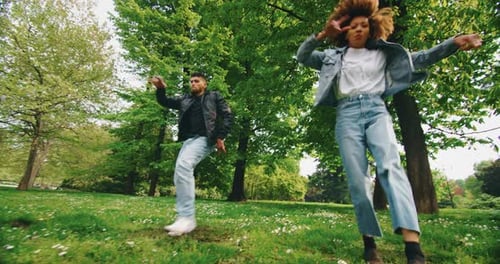 Young Adults Enjoy Dancing in the Park