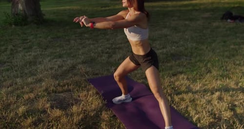 Woman Exercising in Park on Sunny Day