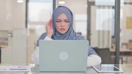 Woman with Headache Working at Computer in Office