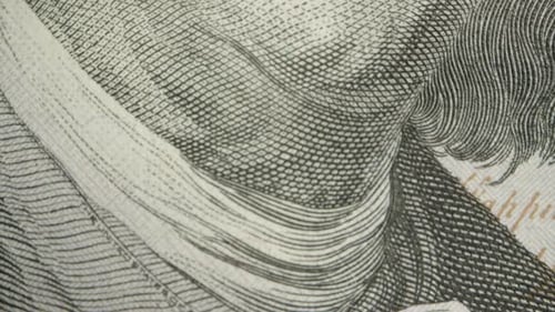 Portrait of Franklin on a hundred-dollar bill. Dolly slider extreme close-up.