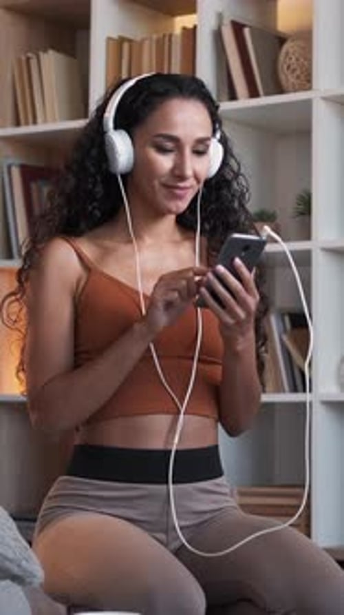 Woman Enjoys Music with Headphones and Mobile Phone