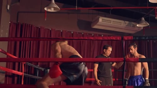 Two young professional boxer having a competition tournament on stage.