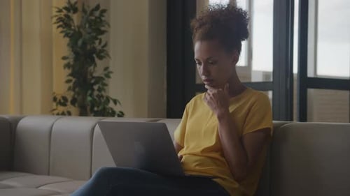 Woman Working on Laptop in Modern Home